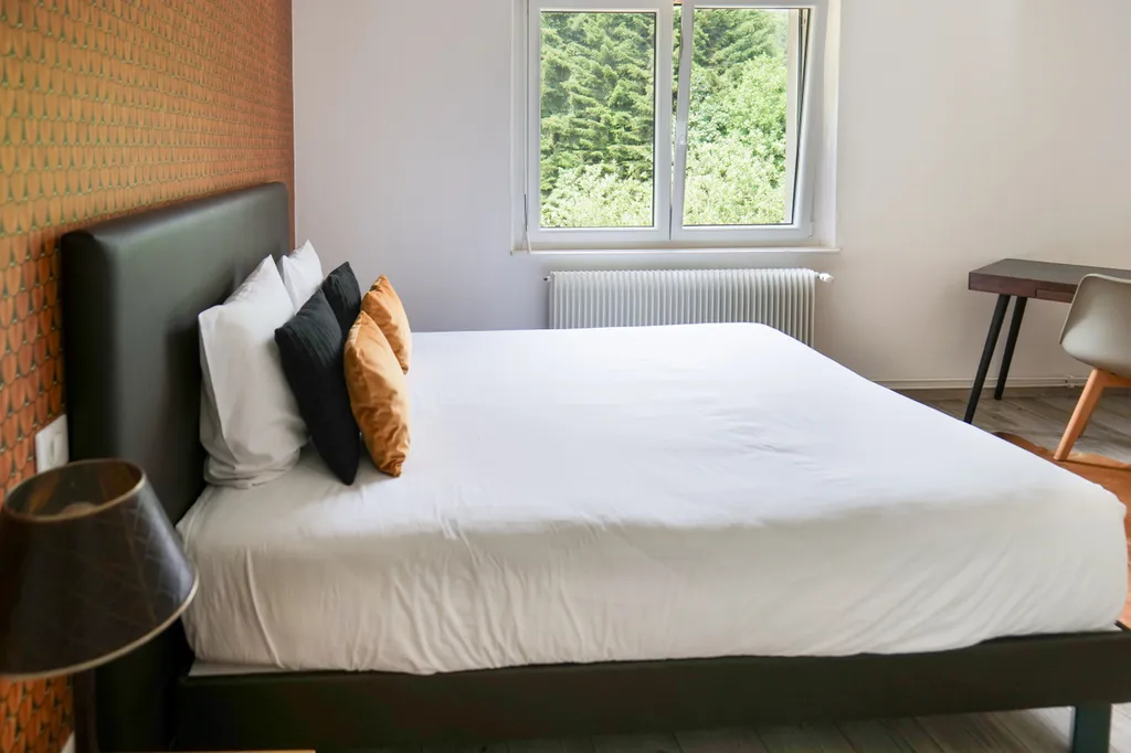 Family hotel suite in Alsace with two interconnecting rooms, surrounded by greenery